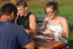 Kendra Peek/kendra.peek@amnews.com 
Travis Watson, Derek Braymer and Nicki Terrell tear into their Moon Pies during the first round of the Moon Pie eating challenge. Watson and Braymer tied from their table to go on to the second round; Watson won the overall challenge. Terrell won the pizza eating challenge.