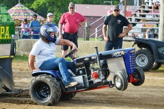 Kacee Bently rides her garden tractor named Phsycho during the pull event Tuesday night.